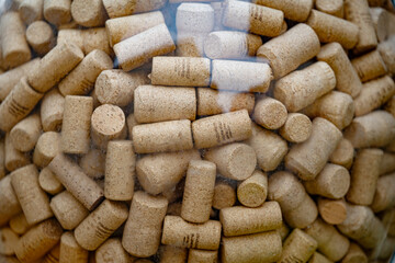 many wine corks in a glass bottle