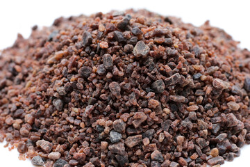 Black himalayan salt on white background.
