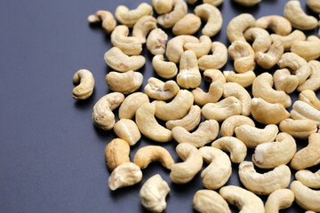 Fototapeta premium Cashew nuts on dark background.