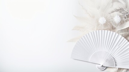 A white fan and white flowers on a white background. The fan is paper and open. The flowers are large and white. The background is white and fades to gray. A clean and elegant image for fan, flower