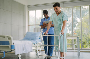 Fototapeta premium Professional physiotherapist examining and care body to young man in rehabilitation physical center. African female doctor treating muscle and joint injuries to male in hospital. Orthopedic concept.