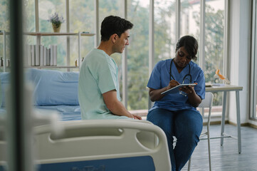 Obraz premium Professional physiotherapist examining and care body to young man in rehabilitation physical center. African female doctor treating muscle and joint injuries to male in hospital. Orthopedic concept.