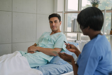 Obraz premium Professional physiotherapist examining and care body to young man in rehabilitation physical center. African female doctor treating muscle and joint injuries to male in hospital. Orthopedic concept.