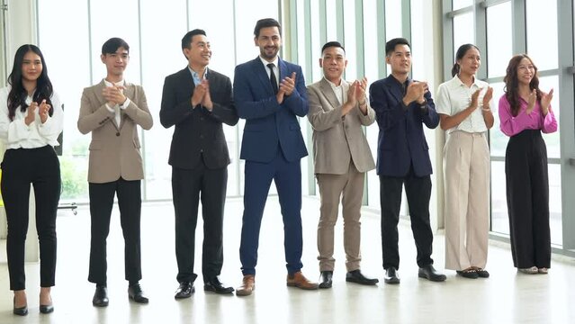 group of diversity business people standing in row and clapping hands together