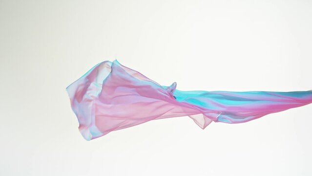 Super Slow Motion of Waving Transparent Colored Cloth. Filmed on High Speed Cinema Camera Phantom VEO 4K, 1000 fps. Isolated on White Background.