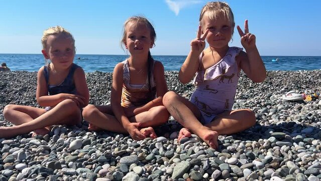 Triplets sisters on the beach