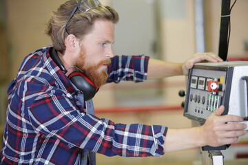 a man operating machines in factory