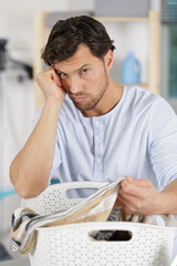 miserable man with basket of laundry