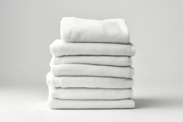 Foto op Plexiglas A stack of folded white towels on a table. AI image. © Friedbert