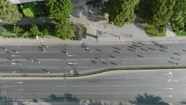 Aerial drone Shot of street Marathon in Skopje, Republic of North Macedonia. Crowd of running people on the city streets