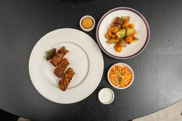 Pork roast with crispy pork crackling top view served with vegetables