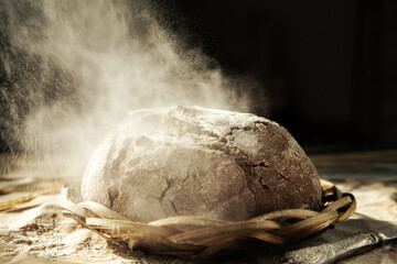 Freshly baked traditional bread in a sprinkle of flour.
