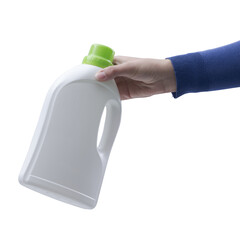 Hand holding a plastic detergent bottle