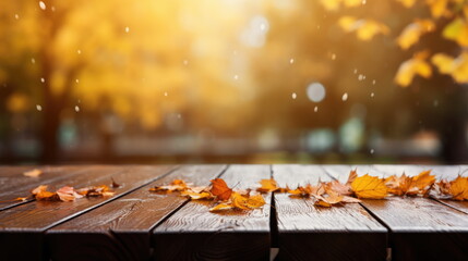 Naklejka na ściany i meble Wooden table with autumn leaves. Blurred autumn background