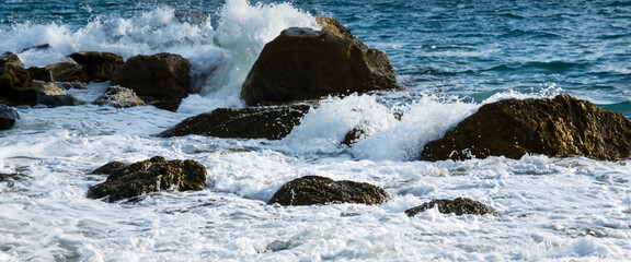 Sea water hits rocks on the beach By the sea with strong waves