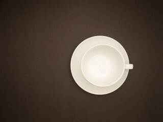 Obraz na płótnie Canvas Top view of an empty white coffee cup on a black background.