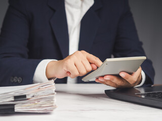 Businessman uses a calculator to calculate the cost of goods sold and profit from a product or...