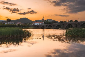 Gordijnen Sunset at the medieval bridge at Ponte de Lima, Portugal. © Sonny