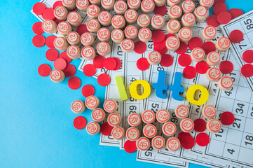 The word "lotto" and scattered wooden kegs on blue background.