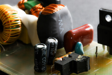 Electronic circuit closeup from low angle. LED light circuit board with capacitors and electrical...