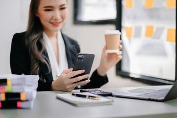 businesswoman working with digital tablet computer and smart phone with financial business strategy layer effect on desk .