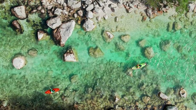 Kayakers on Soca river in Slovenia. Aerial top down tracking shot