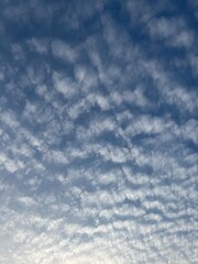 Blue sky with fluffy clouds, natural heavens background