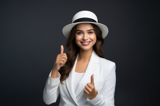 Image of pretty cheerful business woman standing isolated over white background showing thumbs up. Looking camera.