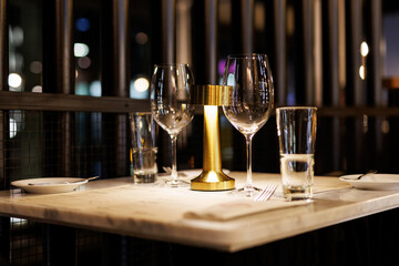 Wine glasses on a table in a restaurant awaiting guests.