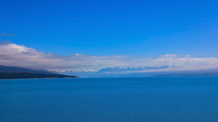 The mist in the morning with  mountain view of  alpine as snow-capped mount peaks and blue lake in Winter mountains