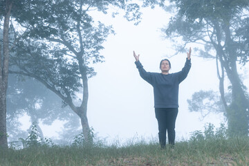 Christian women worship God on a misty morning. Person's hands praying with faith and hope. concept...