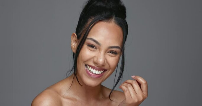 Face, skincare and happy woman wink in studio isolated on a gray background. Portrait, natural beauty and model flirting in spa facial treatment for aesthetic, glow and cosmetic wellness for health