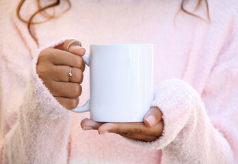 Girl is holding blank white porcelain mug in hands and soft pink sweater. Blank 11 oz ceramic cup

