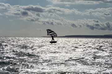 Man with wingfoil sail on the Solent