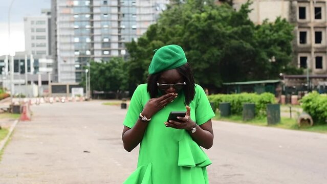 young African woman receiving amazing gift via phone texting app