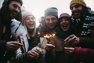 Happy friends celebrating new year eve with sparklers - Cheerful family celebrate Christmas holiday...