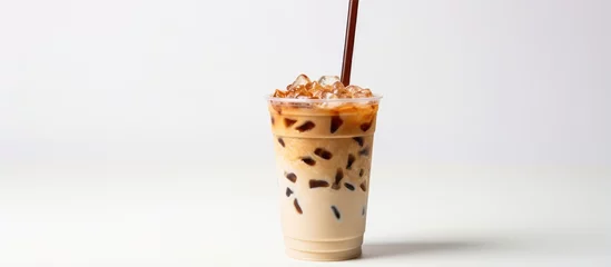 Zelfklevend Fotobehang Summer drink concept Iced latte on a plastic glass and straw isolated on a white background © AkuAku