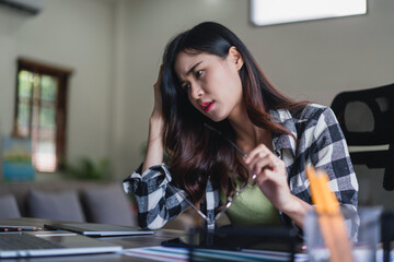 Female artist designer stressed and headache while working graphic design logo at creativity office