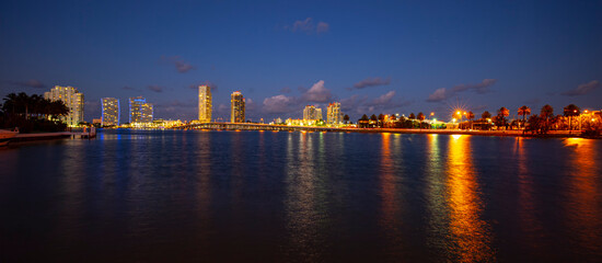 Night panoramic photo of Miami landscape. Bayside Marketplace Miami Downtown behind MacArthur Causeway from Venetian Causeway.