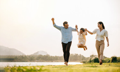Happy family enjoying a day in nature, running and playing together in a beautiful green field, with a sunny sky and a feeling of fun and happiness, Happy Family Day Concept