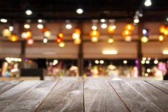 Empty wooden table with bokeh and blur restaurant background, for your photo montage or product display, Space for placing items on the table, product and food display.	
