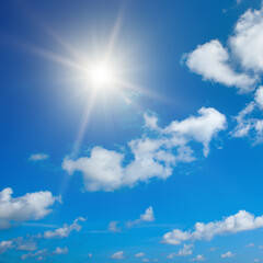 Naklejka na ściany i meble Bright sun on beautiful blue sky with white clouds.