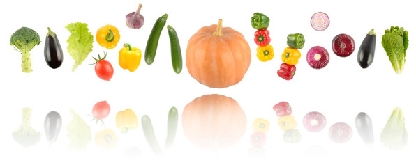 Falling colorful vegetables and fruits with light reflection isolated on white