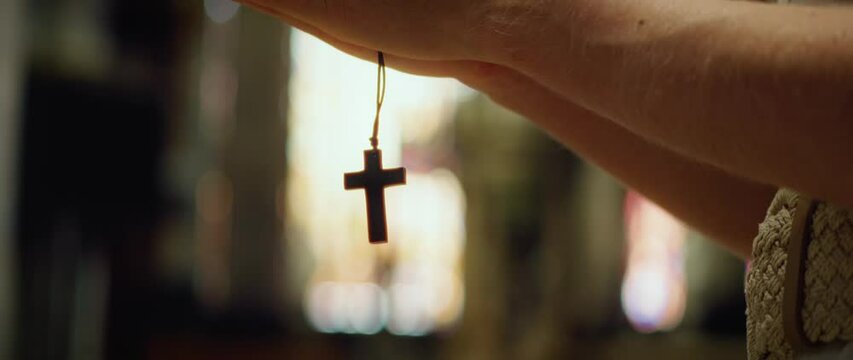 Christian believer with wooden cross in hands when praying. Religious paraphernalia, concept of religion, fasting.