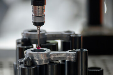 The CMM machine measuring the connecting rod parts.