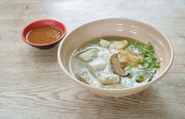 boiled rice with bass fish and mushroom in clear soup on bowl dipping spicy sauce