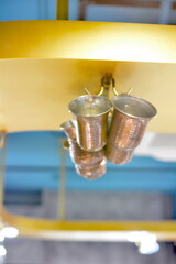 Metal cups hanging from cabinets