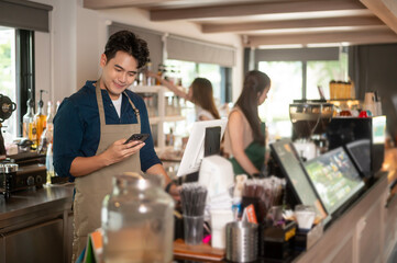 Young Asian service minded barista  with customer in coffee shop