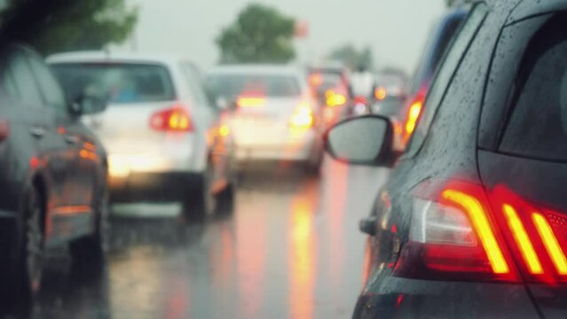 Traffic jams caused by bad stormy weather view from inside the car. Driving in bad weather conditions and blocked in traffic jam.