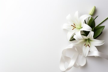 Fototapeta na wymiar White lily bouquet with ribbon on white background.Funeral Concept